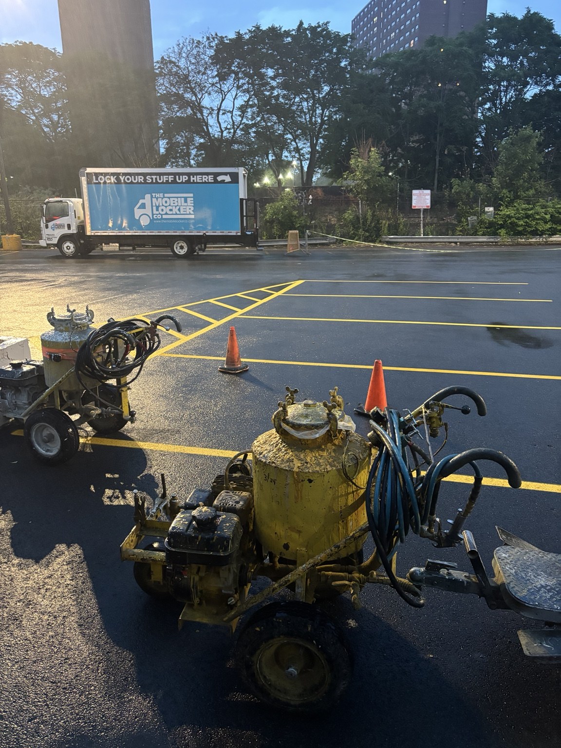 Line striping equipment beside a freshly marked parking lot